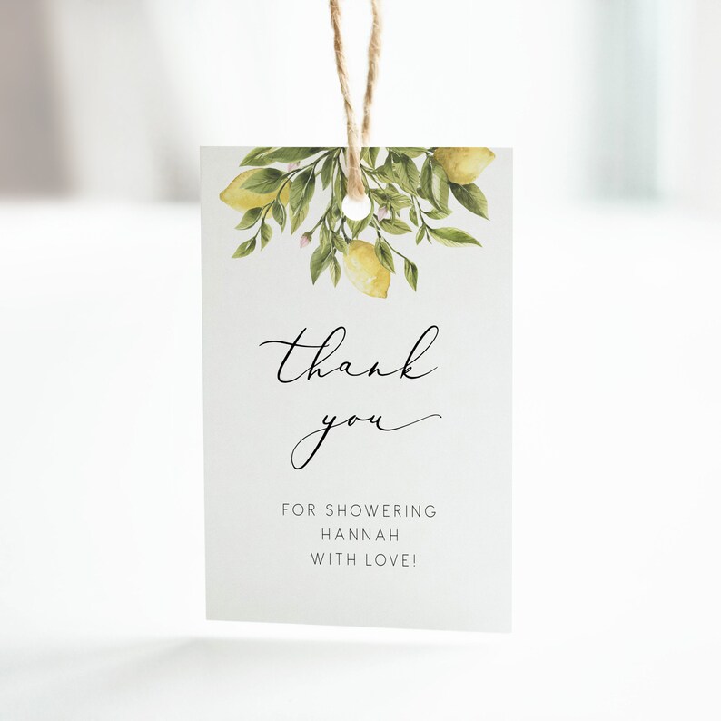 May include: A white thank you tag with a watercolor illustration of lemons and leaves. The text reads "thank you" in cursive and "for showering Hannah with love!"