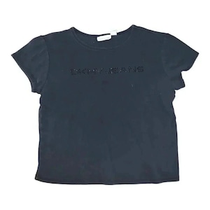 May include: A black short-sleeved t-shirt featuring the text "DKNY JEANS" in rhinestones. The top has a crew neck and a small label at the back. The material looks to be a soft cotton blend, suitable for casual wear.