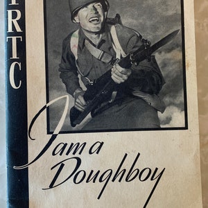 May include: Vintage black and white book cover featuring a soldier in a helmet holding a rifle with a bayonet. The title "I am a Doughboy" is written in cursive. The letters "IRTC" are vertically aligned on the left side.