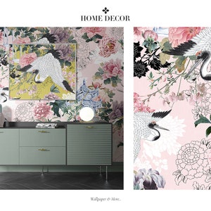May include: A pink floral wallpaper with black and white cranes and a matching framed print. The wallpaper is displayed on a wall behind a green dresser with gold handles.