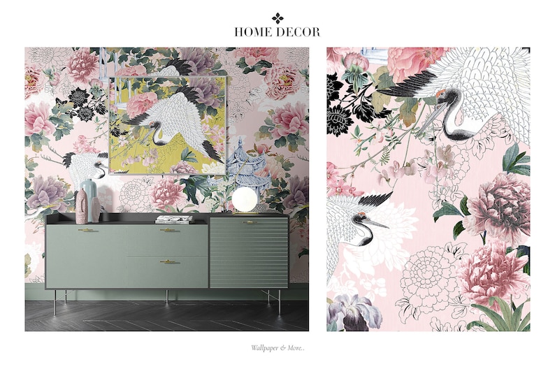 May include: A pink floral wallpaper with black and white cranes and a matching framed print. The wallpaper is displayed on a wall behind a green dresser with gold handles.