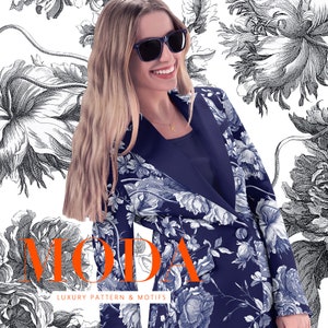 May include: A woman wearing a navy blue blazer with a white floral pattern. The blazer has a black collar and a single button closure. The woman is wearing sunglasses and a gold necklace with a letter K pendant. The background is a white floral pattern.