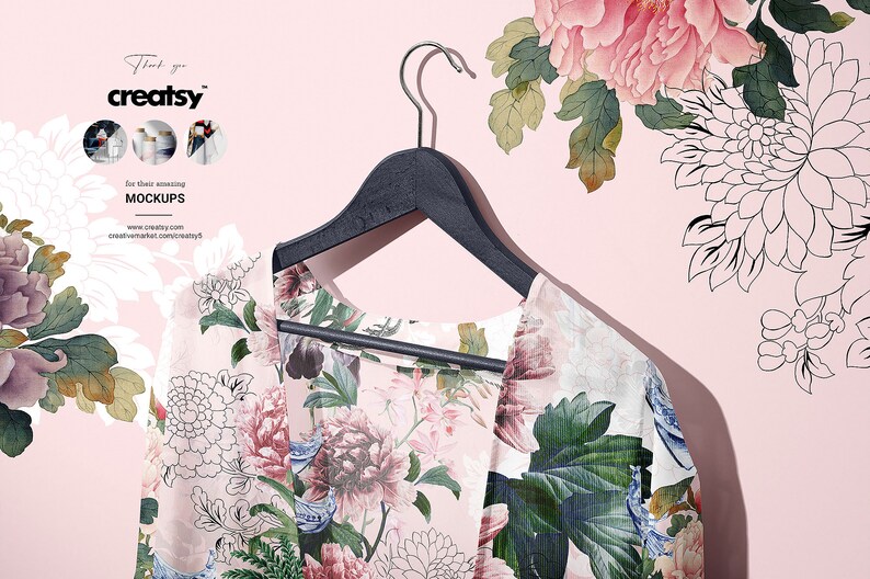 May include: A floral print kimono hanging on a black wooden hanger against a pink background. The kimono has a white background with pink, blue, and green floral patterns.