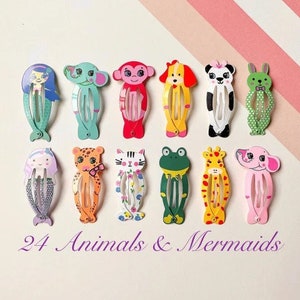 May include: A selection of 12 vibrant hair clips, each designed as an animal or mermaid. The clips showcase a range of characters, such as a mermaid, elephant, monkey, dog, panda, and rabbit. The text "24 Animals & Mermaids" is visible.