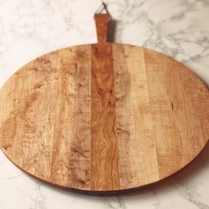 Round Charcuterie Board w/ handle and leather loop made from rescued WI woods.  Various styles & sizes available.  Free Shipping.