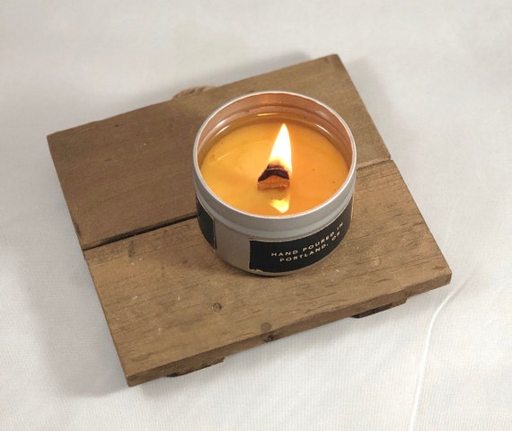 Una mano che tiene un accendino con sopra la scritta candela
