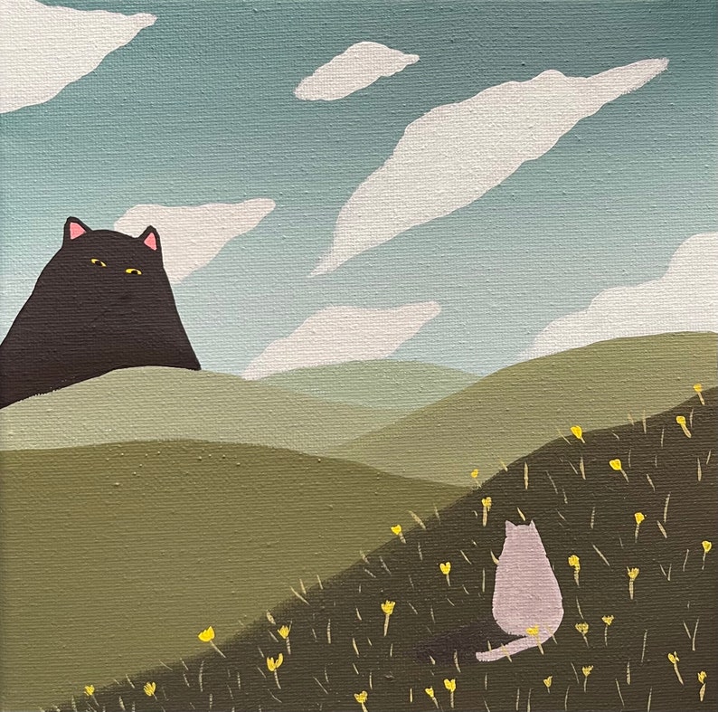 May include: A black cat sits on a green hill, looking towards a white cat sitting in a field of yellow flowers. The sky is blue with white clouds.