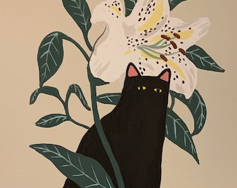 May include: A black cat sits in front of a white lily with brown spots. The lily is in bloom and has green leaves. The cat has yellow eyes and pink ears.