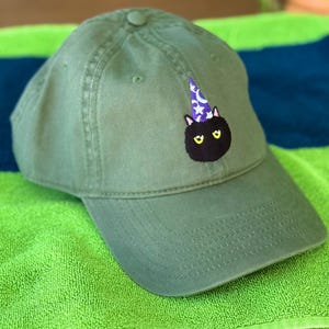 May include: A set of three ceramic mugs with a speckled, matte finish. The mugs are in shades of cream, light gray, and dark gray. Each mug has a simple, minimalist design, perfect for coffee or tea.