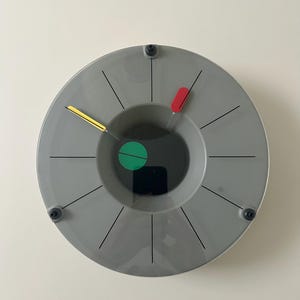 May include: A set of three ceramic mugs with a speckled, matte finish in cream, light grey, and dark grey. Each mug has a simple, minimalist design and a rounded handle.