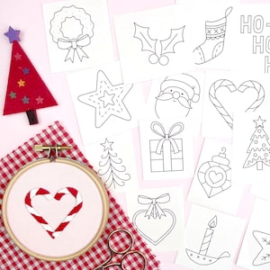 May include: A selection of Christmas embroidery designs. Features a red felt Christmas tree with star decorations, a heart-shaped candy cane embroidery, and line art illustrations of festive elements such as baubles, Santa, and a wreath.