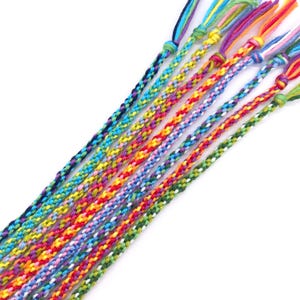 A bundle of smooth, colourful threads ready for weaving. The kit comes with 48m of cord in 12 bright shades, pre-cut and ready to use — just pick your colours and get braiding.