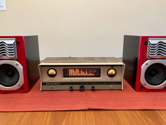 A one-of-a-kind hand-wired Bluetooth hi-fi amplifier built in a raw 'rat rod' industrial aesthetic — functioning audio art that looks like it escaped a mad scientist's workshop.