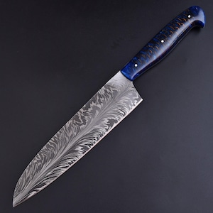May include: A Damascus steel chef's knife with a patterned blade and a blue and brown handle. The blade has a unique, flowing design. The handle is a deep blue with brown accents and white dots. The knife is designed for kitchen use.