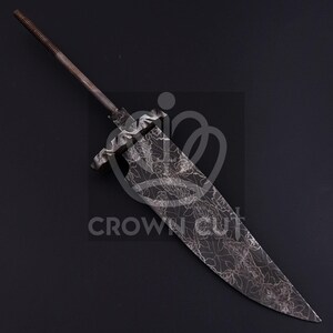 May include: A metal sword blade with a floral pattern etched into the surface. The blade has a long, pointed tip and a textured handle. The text "CROWN CUT" is visible.