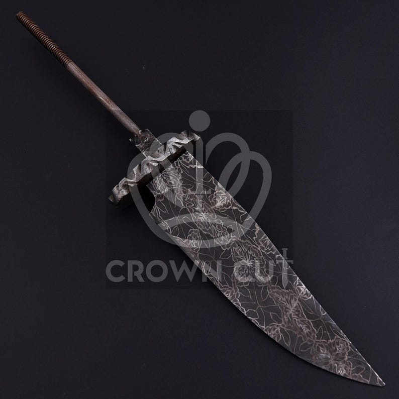 May include: A metal sword blade with a floral pattern etched into the surface. The blade has a long, pointed tip and a textured handle. The text "CROWN CUT" is visible.