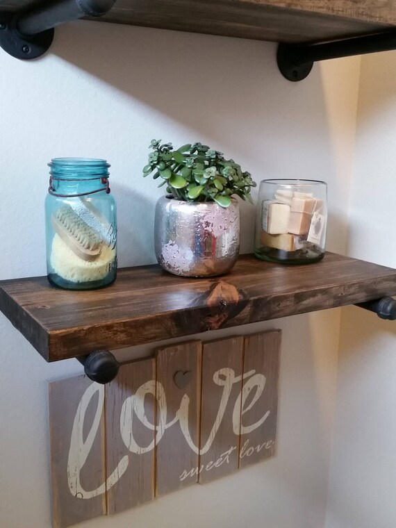 Stained Wood Shelves With Rustic Steel Pipe Brackets Image 0