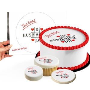 May include: A white cake with red frosting and the text "The best HUSBAND" in red. The image also shows a cupcake, a cookie, and a print with the same design. The print says "Actual print".