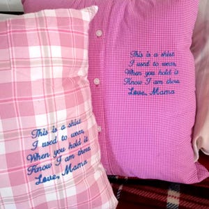 May include: Two pink and white plaid pillowcases with the text "This is a sheet I used to wear, When you hold it Know I am there Love, Mama" embroidered in blue thread.