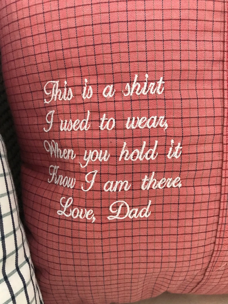 May include: A red and white checkered pillow with white embroidery that reads "This is a shirt I used to wear, When you hold it Know I am there Love, Dad".