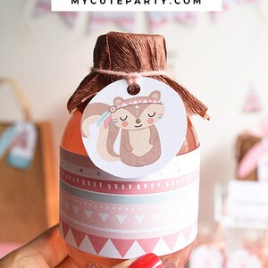 May include: A small clear bottle with a pink and white patterned label featuring a cartoon squirrel. The bottle is topped with a brown paper cover and a white circle with the text "MYCUTEPARTY.COM".