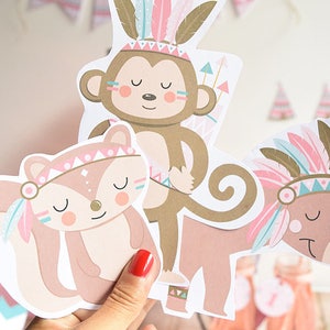 May include: Three paper cutouts of animals wearing Native American headdresses. The animals are a monkey, a fox, and a deer. The headdresses are pink, blue, and gold. The cutouts are on a white background. MYCUTEPARTY.COM is printed at the bottom of the image.