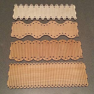 May include: Four wooden strips with different patterns of holes and cutouts. The strips are arranged vertically, with the top strip being the lightest in color and the bottom strip being the darkest.