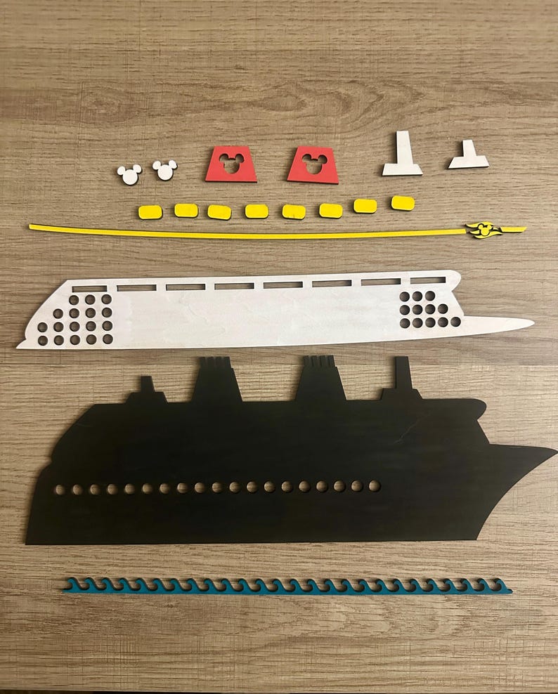 May include: A wooden craft kit to build a cruise ship. The kit includes a white ship hull, a black ship silhouette, yellow and red pieces, and a blue wave piece.