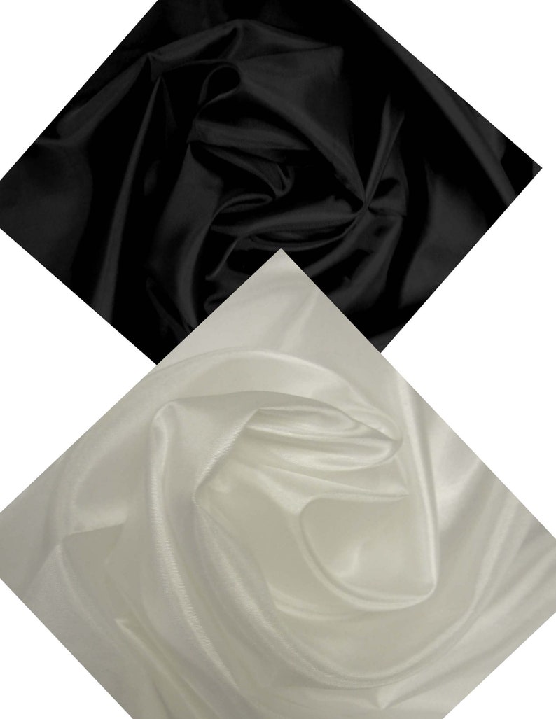 May include: Two pieces of fabric, one black and one white, are draped and folded in a diamond shape. The fabric has a smooth, silky texture.