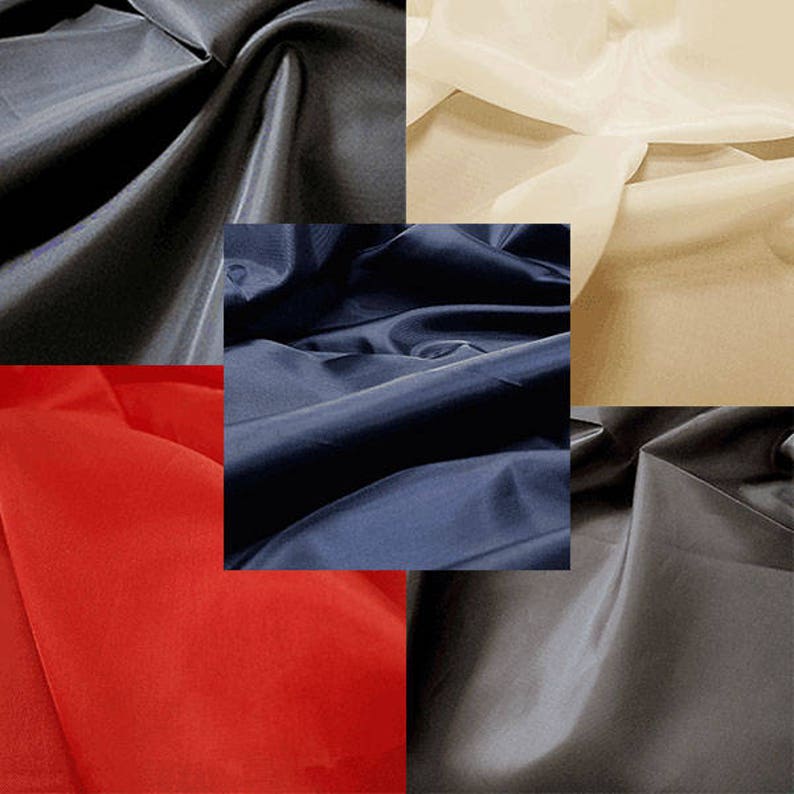 May include: Five fabric swatches in different colors: black, navy blue, red, beige, and gray. The fabric has a smooth, silky texture.