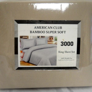 May include: A beige king-sized sheet set from American Club, labeled "Bamboo Super Soft 3000". The packaging shows a photo of a bed with a white sheet set and two pillows.