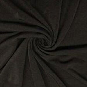 May include: Close-up of a dark brown fabric with a swirling pattern. The fabric appears soft and has a subtle texture, with folds and shadows creating depth. The colour is a deep, neutral tone.