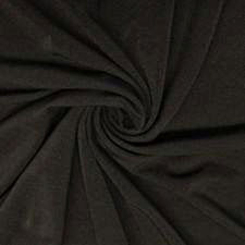 May include: Close-up of a dark brown fabric with a swirling pattern. The fabric appears soft and has a subtle texture, with folds and shadows creating depth. The colour is a deep, neutral tone.
