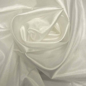 May include: White sheer fabric draped and folded to create a soft, flowing, and elegant design.