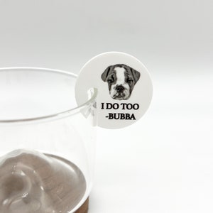 May include: White round sticker with a black and white photo of a bulldog puppy. The sticker says "I do too -Bubba".