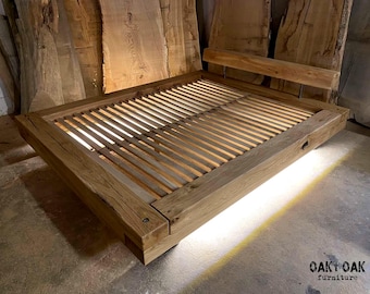 May include: A handcrafted wooden bed frame with a slatted base and a headboard. The bed is made of light-colored wood and has a modern, minimalist design. The bed frame is sturdy and appears to be well-constructed. The bed is a piece of furniture.