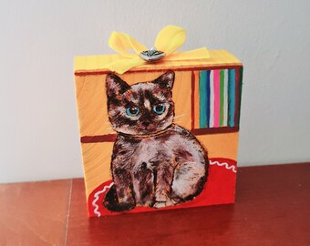 Funny decorative cat with little yellow bow