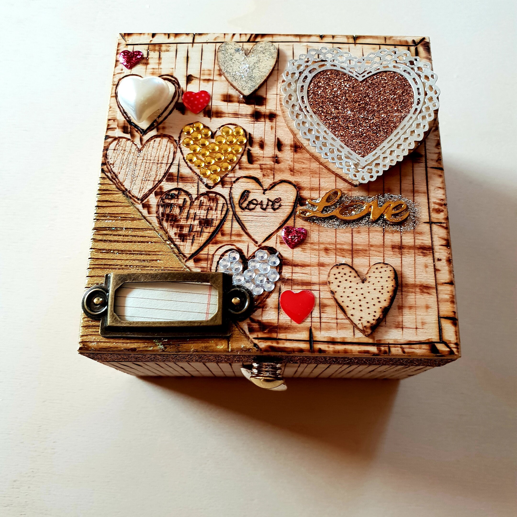 Square wooden jewelry box decorated with hearts