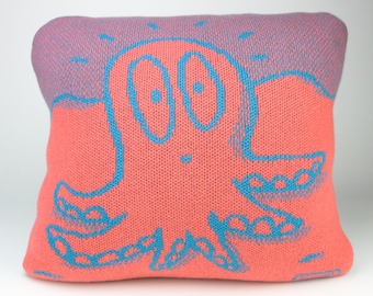 40cm knitted octopus cushion. Coral & turquoise merino lambswool. Handmade in UK.