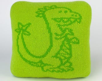 25cm knitted dinosaur cushion. Lime & mid green merino lambswool. Handmade in UK.