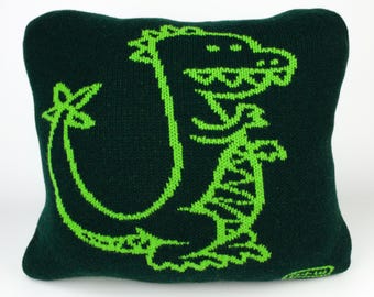 40cm knitted dinosaur cushion. Mid green & dark green merino lambswool. Handmade in UK.