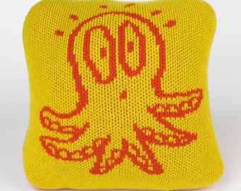 25cm knitted octopus cushion. Red & yellow merino lambswool. Handmade in UK.