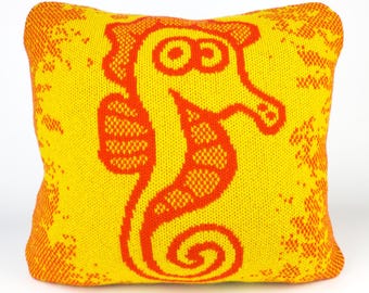 40cm knitted seahorse cushion. Red & yellow merino lambswool. Handmade in UK.