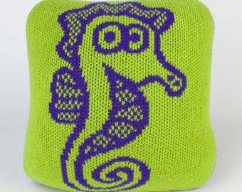 25cm knitted seahorse cushion. Green & purple merino lambswool. Handmade in UK.