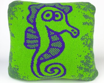 40cm knitted seahorse cushion. Green & purple merino lambswool. Handmade in UK.