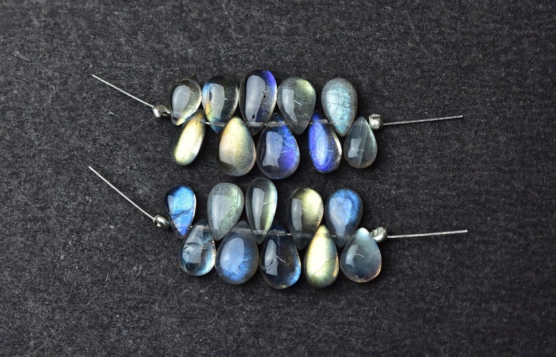 K&ouml;nnte beinhalten: Zwei Str&auml;nge aus irisierenden blauen und gr&uuml;nen Labradorit-Edelsteinen in Tropfenform.