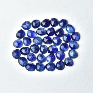 May include: A collection of 30 faceted blue kyanite gemstone beads. The beads are oval shaped and have a smooth, polished finish.
