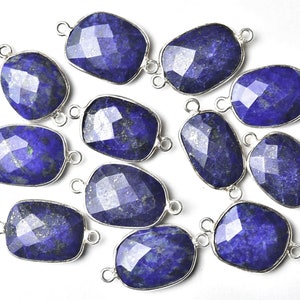 May include: Twelve lapis lazuli gemstone connector charms with silver-toned metal settings. Each charm has two loops for attaching to jewelry.