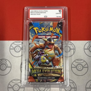 May include: A sealed Pokémon trading card pack from the Mega Evolution series, featuring Kangaskhan. The pack is encased in a protective case with a grade of 10, labeled "GEM-MT". The packaging displays a colorful design with the Pokémon logo.