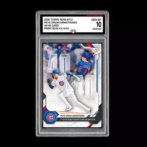 May include: A 2026 Topps Now #712 Pete Crow-Armstrong 40/40 card in a protective slab. The card features a baseball player in a pinstriped uniform running, with the text 40/40, Topps Now, and 7th player in MLB history to join the 40/40 club.
